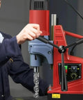 Kickass Portable Magnetic Drill Press Tough As Nails Industrial Grade Workhorse For Heavy Duty Steel And Metal Fabrication With Ac Power Smooth Vertical Action On Job Sites, close-up of operator using drill.