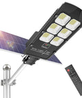 Solar Flood Light Outdoor Lamp Dusk To Dawn LED Street Light With Motion Sensor And Remote Control, mounted on pole.