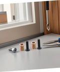 Wood Threaded Insert Kit For Furniture Repair 50 Pcs with nuts, bolts, wrenches on table near window corner
