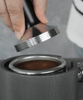 Hella Solid 2 In 1 58Mm Espresso Coffee Tamper And 5 Pin Needle Stirrer Distributor being used on coffee grounds in portafilter.