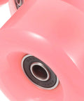 Close-up of pink double row roller skate wheels with bearings, semi jelly outdoor wheels for inline and quad skates, sturdy replacement parts.