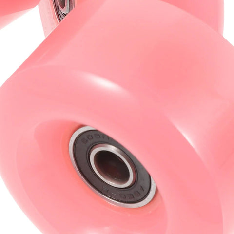 Close-up of pink double row roller skate wheels with bearings, semi jelly outdoor wheels for inline and quad skates, sturdy replacement parts.