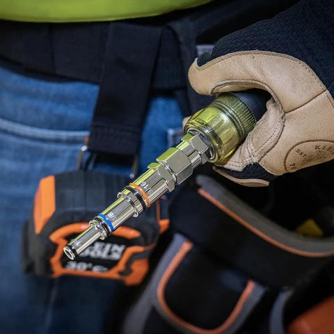 Gloved hand holding Do-It-All 9-In-1 Pass-Through Nut Driver With Cushioned Grip, SAE Hex Sizes From 3/16 To 3/4 Inch in workshop.