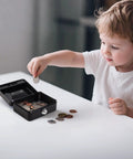 Child placing coin into Compact Locking Cash Box For Coins And Meds With A Secure Keyed Lock, Tiny Yet Sturdy Steel Money Box, Black