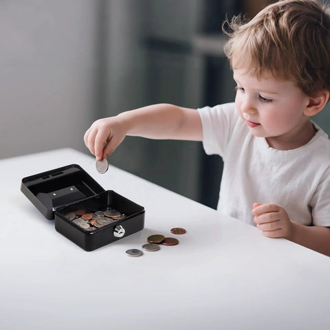 Child placing coin into Compact Locking Cash Box For Coins And Meds With A Secure Keyed Lock, Tiny Yet Sturdy Steel Money Box, Black