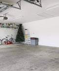 Spacious garage with two bicycles, shelves, and a Two Foot LED Strip Light 1250 Lumens 4000K Cool White Ceiling Fixture For Kitchen And Garage