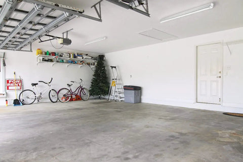 Spacious garage with two bicycles, shelves, and a Two Foot LED Strip Light 1250 Lumens 4000K Cool White Ceiling Fixture For Kitchen And Garage