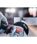 Street Tough 4.5 Inch Angle Grinder Featuring X Lock Tool Free Disc Swap Mount cutting through metal with sparks flying.