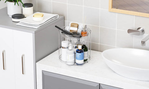 Totally Slick No Hassle 360 Spin Vanity Organizer Two Tier Clear Acrylic Rotating Storage for perfume and lotion on a countertop.