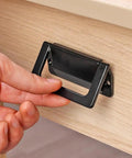 Hand pulling on 2 Pack Foldable Zinc Alloy Drawer Pulls For Cabinets And Furniture Hidden Metal Handles In Black, installed on drawer.