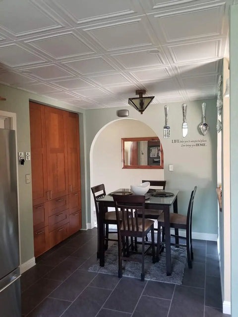 Glue Up Foam Ceiling Tiles White Pack Of Eight Covering 21.6 Square Feet Lightweight Insulating Popcorn Ceiling Cover Paintable With Water Based Paint Easy To Install And Clean in a dining area