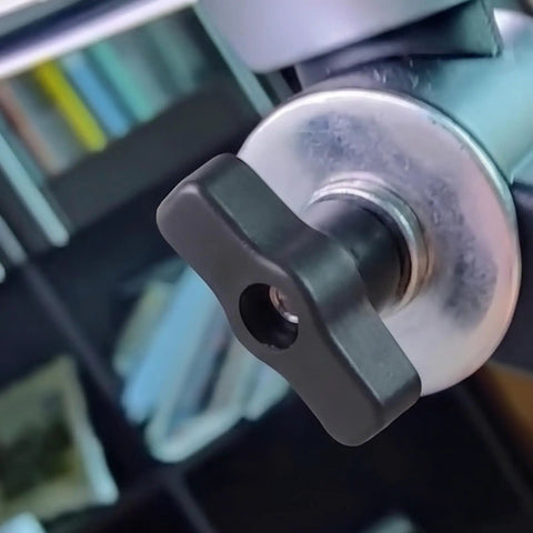 Close-up of 10 Pack Black M8 Through Hole T Knobs with plastic and copper design on machinery for quick release clamping.