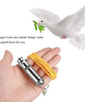 Hand holding Stainless Steel Ultrasonic Pigeon Whistle With Lanyard For Bird Training And Pet Behavior Improvement