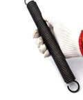 Rock Solid Heavy Duty Extension Spring Forged From Premium Spring Steel For Superior Tensile Strength And Reliable Elasticity Ideal For Auto Fixes And Diy Builds Featuring Five Mm Wire Diameter Thirty Two Mm Outer Size And Five Hundred Mm Length held in gloved hand.