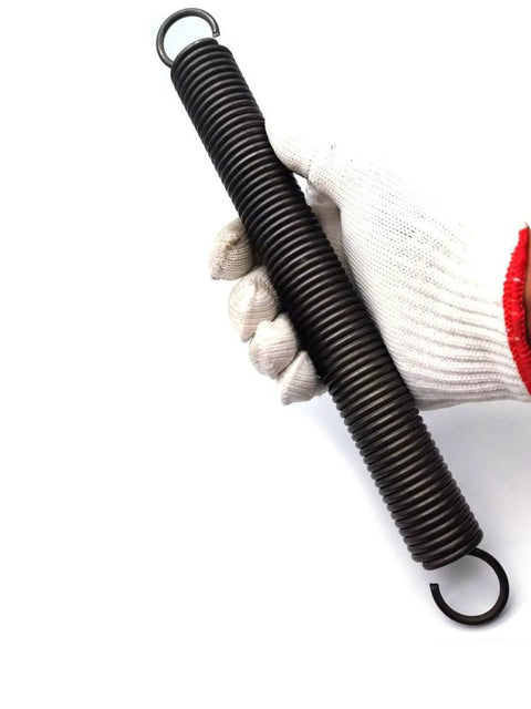 Rock Solid Heavy Duty Extension Spring Forged From Premium Spring Steel For Superior Tensile Strength And Reliable Elasticity Ideal For Auto Fixes And Diy Builds Featuring Five Mm Wire Diameter Thirty Two Mm Outer Size And Five Hundred Mm Length held in gloved hand.
