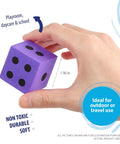 Hand holding purple die from Jumbo Foam Dice Set For Classroom And Home Schooling 1.96 Inch Dice In Assorted Bright Colors Kid Safe EVA Foam