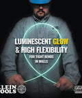 Worker holding Mid Flex Glow Rod Set With Splinter Guard Coating, Six 18 Inch Glow Rods illuminated in dark workspace, Made In USA.