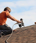 Worker on roof using pneumatic tool; ideal use for AirAid Air Tool Conditioner, Protective Coating, And Rust Inhibitor For Tools.