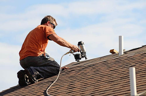 Worker on roof using pneumatic tool; ideal use for AirAid Air Tool Conditioner, Protective Coating, And Rust Inhibitor For Tools.