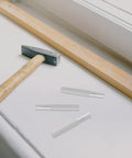 Smooth As Butter Soft Close Dampers For Trash Cans And Cabinet Doors 6 Pack Hydraulic Buffer Bumpers and hammer on work surface.