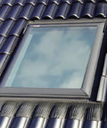 Edw M02 Skylight Flashing Top Shelf Solution For High Profile Tile Roofs Featuring Adhesive Underlayment on a tiled roof with blue sky.