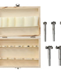 Front view of a five-piece hinge jig drill bit set with adjustable positioning beside a two-compartment wooden storage box.