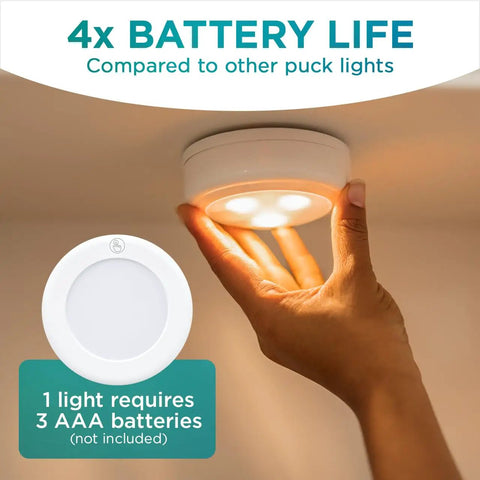 Ultra Thin Wireless LED Touch Lights Pack Of 2 For Under Cabinets Closets And Countertops Battery Operated Puck Lights You Stick On Push Lights For Quick Tool Free Setup Modern Home Decor Accent shown being installed under cabinet with hand for scale