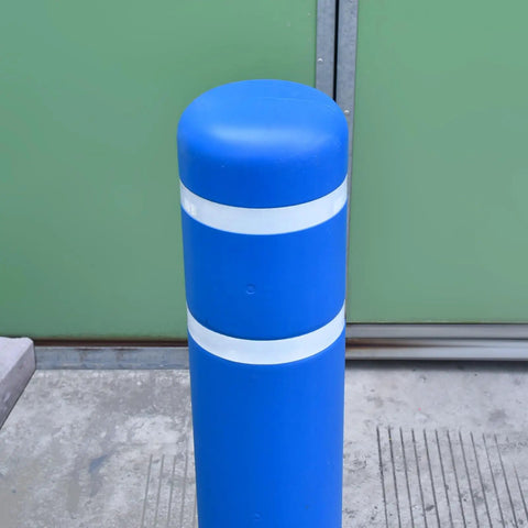 Tough As Nails Blue Safety Bollard Cover 6 Inch Wide 46 Inch Tall with reflective tape protecting a pole in a commercial area.