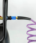Connected purple reinforced polyurethane air hose, ten feet long, one quarter inch, coiled retractable, attached to air compressor.