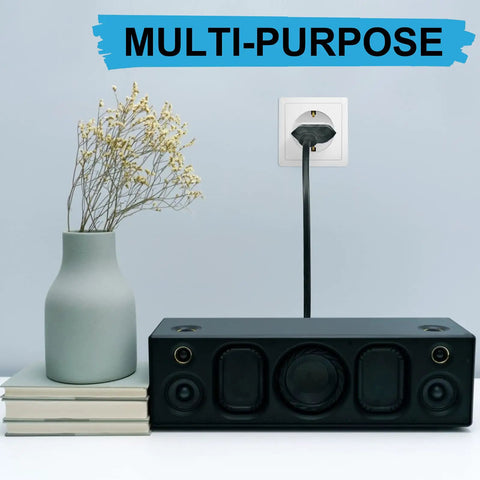 Six Pack US To Europe Plug Adapters Type C Travel Converter plugged into European wall outlet near speaker and vase