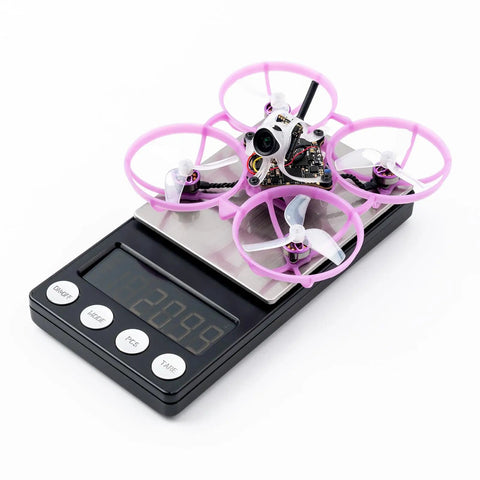 Ultra Light Brushless Whoop Quadcopter With Matrix 5IN1 II Flight Controller on scale weighing 20.9g, 1614-3B Props visible