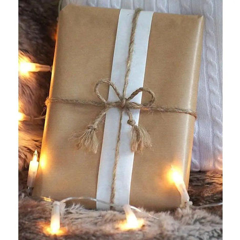 Brown gift wrapped with Heavy Duty Brown Jute Twine 328 Feet 2.5mm 4 Ply String, surrounded by string lights.