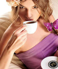 Woman in purple dress holding coffee cup and saucer with pod from Bold Dark Roast Coffee Pods Variety Pack 40 Count For Keurig K Cup Machines Single Serve Cups World Roasts French Roast Espresso Roast Italian Roast Rich Flavor.