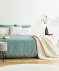 Sturdy Tripod Floor Lamp With Adjustable Height And 100 Percent Metal Body in a bedroom with linen drum shade, brushed nickel finish.