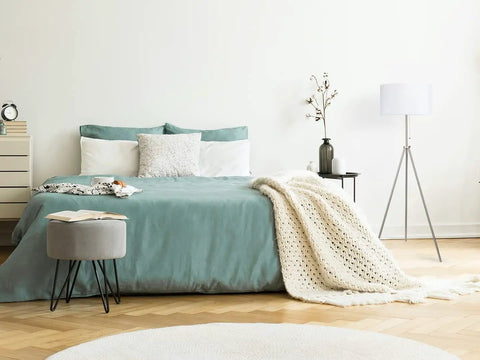 Sturdy Tripod Floor Lamp With Adjustable Height And 100 Percent Metal Body in a bedroom with linen drum shade, brushed nickel finish.
