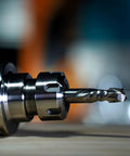 Close-up of a carbide compression router bit with 1/4 inch shank, part of the Compression Router Bits Set Five Pieces With One Quarter Inch Shank And One Quarter Inch Cutting Diameter Carbide Up Down CNC Router Bits For Woodworking Carving Slotting And Edge Cutting Pro Grade Durability And Clean Tear Free Cuts.