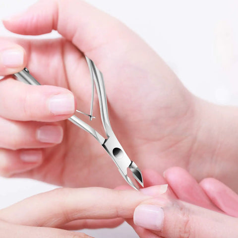 Person using stainless steel trimmer from 5 In 1 Cuticle Care Kit With Stainless Steel Trimmer Pusher Nipper Dead Skin Fork And Triangle Nail Scraper