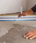 Person using Self Leveling Concrete Tool Kit With Spike Shoes And Roller Needle 28mm Pro Grade Floor Leveling Gear for smooth surfaces.