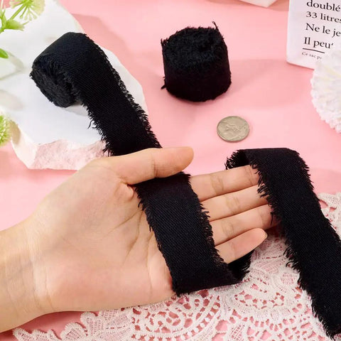 Polycotton Denim Fringe Ribbon 1 Inch Wide Raw Edged 4 Yards Pack For DIY Jewelry held over lace fabric on pink background
