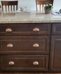 3 Inch Bin Cup Drawer Cabinet Pulls In Antique Copper Finish installed on kitchen drawers, highlighting easy installation and style.