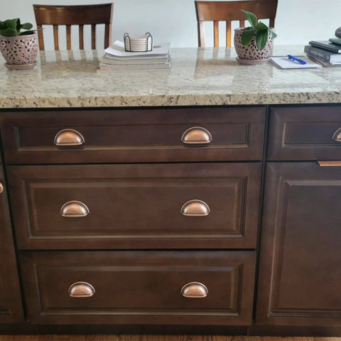 3 Inch Bin Cup Drawer Cabinet Pulls In Antique Copper Finish installed on kitchen drawers, highlighting easy installation and style.