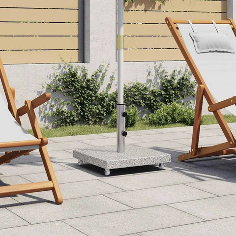Granite and stainless steel tube parasol base with wheels in patio setting, easy mobility and quick positioning, gray outdoor stand with chairs.