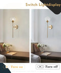 Glass Globe Wall Sconce In Brushed Brass With Clear Globe Mid Century Modern Bedroom Bedside Lighting displayed on a wall.