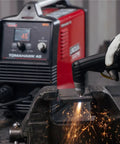 Lincoln Tomahawk 45 Handheld Plasma Cutter With 2.8 Inch LCD Screen cutting metal, sparks flying in workshop scene.