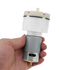 Hand holding 12V Micro Vacuum Pump for Aquarium Oxygen, Whisper Quiet DC Air Pump with 15 L/Min Flow, Low Noise Electric Aquarium Aerator