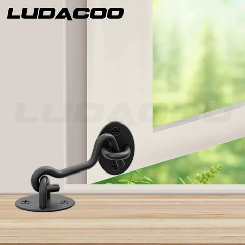Bulletproof 3 Inch Hook And Eye Gate Latch Straight Up Heavy Duty Barn Door Lock on a door frame with a black finish.