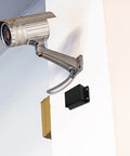 Durable Waterproof Outdoor Electrical Box Plastic Enclosure With Fixed Ear 115x90x55mm Black installed on white wall with security camera