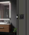 Pocket Door Lock Hardware Matte Black Privacy Lock With Indicator installed on sliding door in modern bathroom setting.