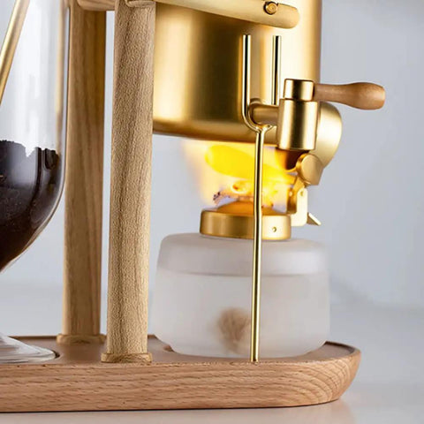 Top Shelf Belgian Siphon Coffee Maker With Clear Glass Chamber And Sleek Silver Base for rich flavor extraction.