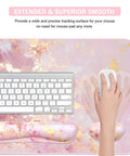 Top view of a 4 In 1 Large Gaming Mouse Pad For Gamers With Keyboard Wrist Rest And Mouse Wrist Support Extended Waterproof Desk Pad For Home Office Study And Gaming Pink Gold Marble Finish, showing keyboard and hand holding mouse.